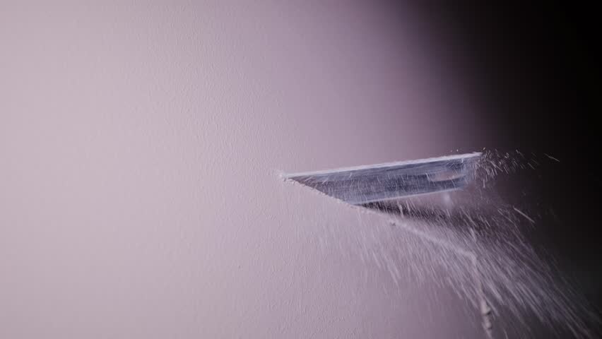 Fine closeup showing precise manual cutting of gypsum board in workshop