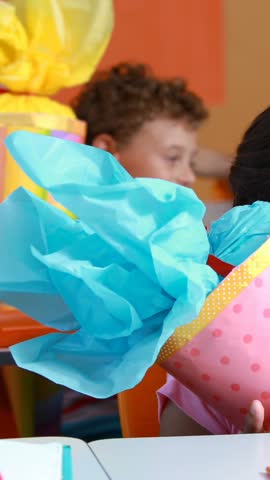 Animation of books moving over happy school children in classroom. children's book day, reading and education concept digitally generated video.