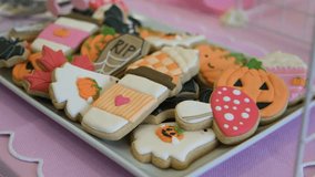 Colourful Halloween cookies decorated with icing in pumpkin, ghost, and bat shapes on a tray. Festive autumn treat scene with soft pastel background. - Powered by Shutterstock - Get 15% off with code: PIKWIZARD15