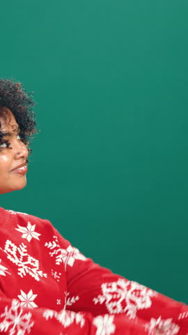 Face, woman and excited for Christmas, pointing and promotion for December discount offer in studio. Green background, festive season and black person with suggestion for Xmas deal, happy and sale