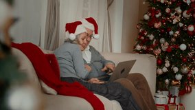 Happiness and joy in Christmas vacation, aged man and woman calling by video. Joyful aged spouses communicating online with family, congratulations and celebration, good emotions and positivity - Powered by Shutterstock - Get 15% off with code: PIKWIZARD15