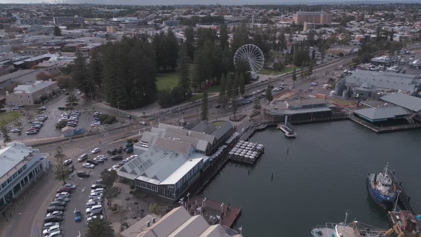 Aerial footage panning around the docks of Fremantle, Esplanade Park and Bathers beach in Perth, Western Australia.