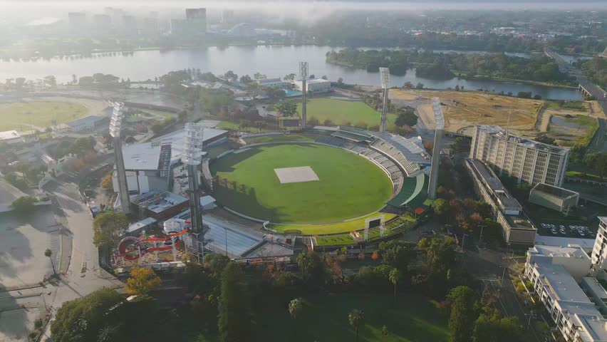 Aerial footage panning away from the Western Australian Cricket Association, a cricket ground located in East Perth, gradually revealing the lush greenery of Queens Garden.