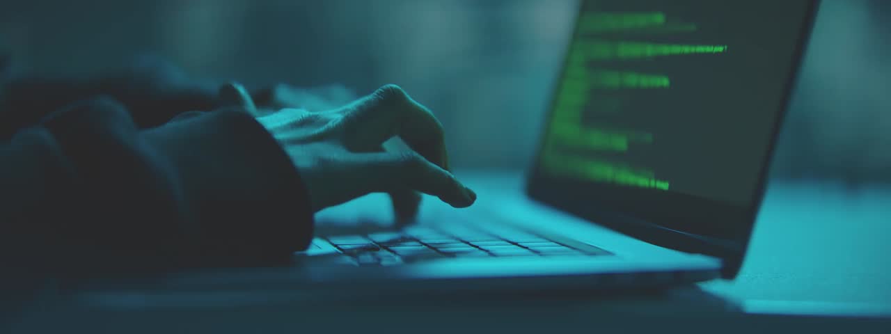 A person typing on a laptop