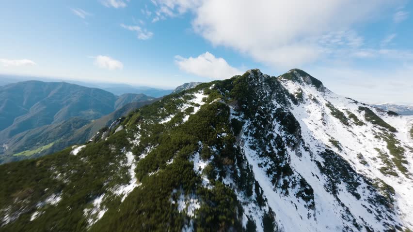 Flight right by the edge of a mountain peak in Triglav National Park in Slovenia