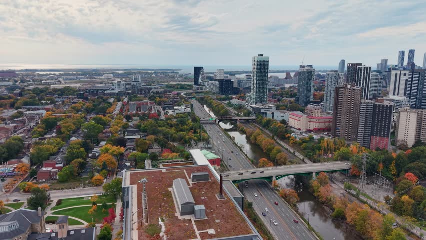 Beautiful drone view of the Don Valley Parkway, Riverdale Park, the Don River and the downtown Toronto skyline looking southwest in autumn, Ontario, Canada. Toronto architecture and skyscrapers.