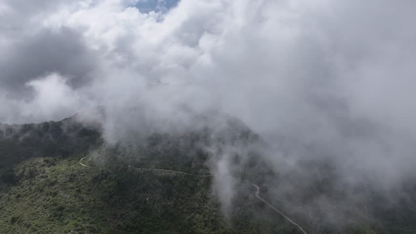 Ruins of Citadelle Laferriere, fortress on mountaintop shrouded in clouds, Cap-Haïtien, Haiti. Aerial forward