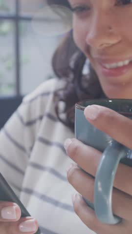 Animation of data processing over woman using smartphone and drinkin tes at home. global connection and digital interface concept digitally generated video.