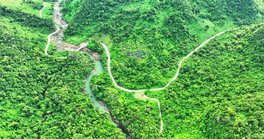 Aerial view of scenic Truong Son forest in Northern Vietnam, the winding mountain pass road through the rugged mountain slopes is very beautiful