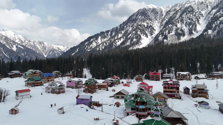 Peaceful winter snowfall blankets Pakistan’s northern mountains. Flakes drift over pine ridges, frozen streams, and misty valleys. Shot 4K 16:9, color-graded, DRONE SHOT
