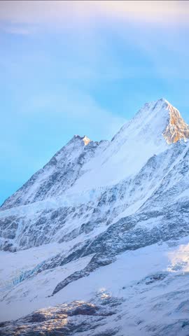 Timelapse of zoom in mountain First snow capped mountain peak above Grindelwald in Switzerland