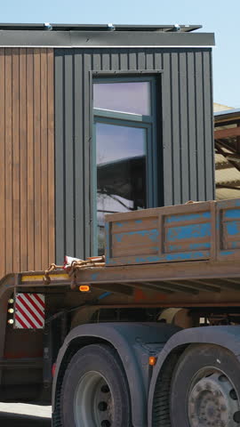 Prefabricated tiny house moving on truck trailer