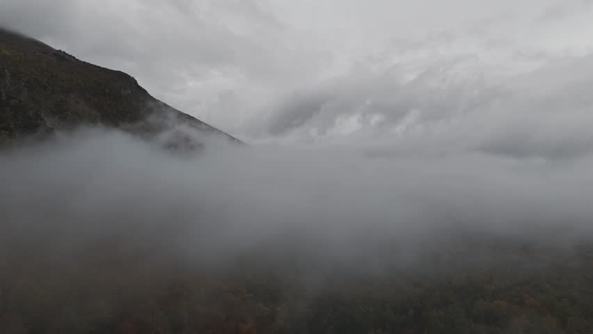 Aeral shot of foggy mountain in autum
