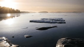 Calm sea with ice floes at sunrise reflecting the golden light of the morning sun - Powered by Shutterstock - Get 15% off with code: PIKWIZARD15