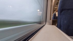 Train window view showing blurred landscape passing by during a travel journey - Powered by Shutterstock - Get 15% off with code: PIKWIZARD15