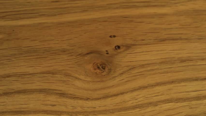 White sugar crystals are sprinkled onto wooden surface. A big pile of sugar, a lot of sugar.