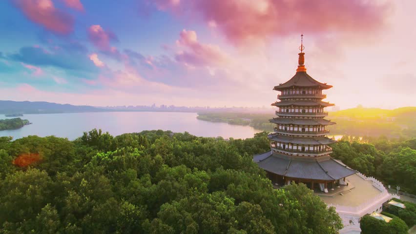 Leifeng Pagoda stands tall at sunset overlooking the lake in Hangzhou China