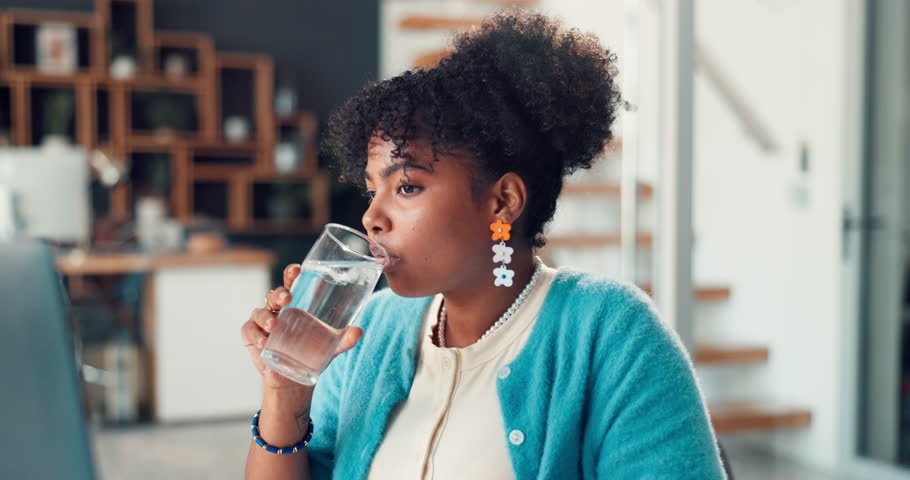Woman, drinking water and toothache in office at startup with stress, cavity or sore with gum disease. Person, writer and pain with sensitive teeth, massage and glass with project at creative agency
