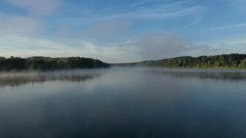 Low Altitude Drone Flight over Foggy River in Summer