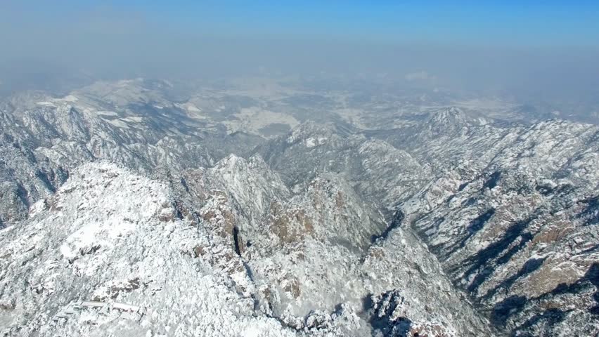 Snowy mountain range under a clear blue sky on a cold winter day landscape view