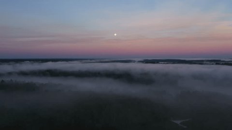 Drone Moving over Foggy Countryside