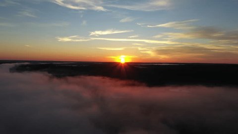 Aerial Retreat over Sunrise Mist