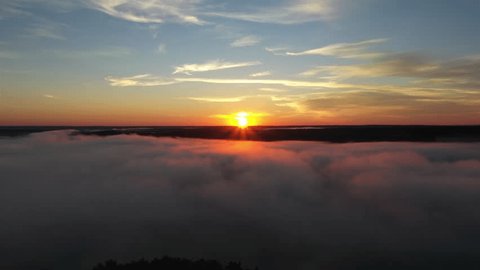 Aerial Sunrise Flight over Mist