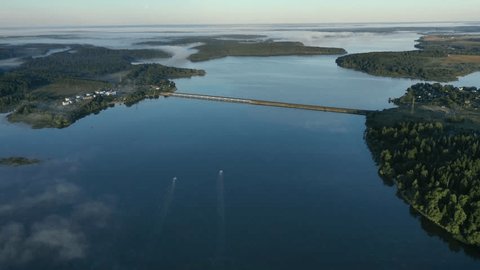 Aerial Drone View of Bridge Over Calm River in Summer Fog