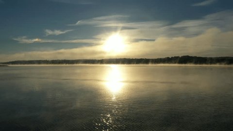 Drone Approaching Sunrise above Calm River