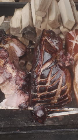 Prague Ham is cooked on spit of grill at Old Town Square in Prague. Traditional Old Prague Ham is type of brine-cured, stewed, and mildly beechwood-smoked boneless ham originally from Prague
