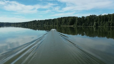 Aerial View of Motorboat on River with Greenery