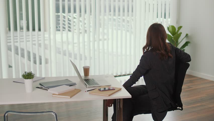 Employee Wellbeing and Healthy Office. Manager Practices Seated Spinal Twist for Thoracic and Lumbar Spine to Relieve Tension, Flexibility