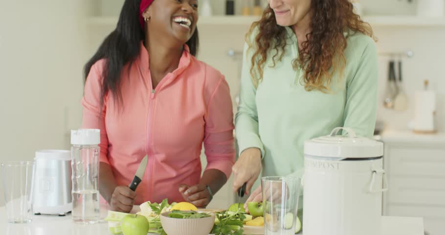 Friends grabbing knives slicing fruits and filling blender jar sparking golden swirl showing health. Collaboration, freshness, wellness, vibrant, lifestyle, healthy eating, teamwork