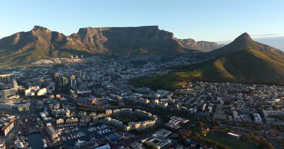 Aerial panoramic view of Cape Town with natural landmarks Table Mountain and Lion's Head at sunset, Western Cape Province, South Africa. 