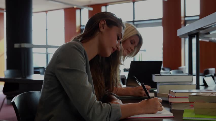 Students studying at library while translucent red overlay sliding in, code scrolling verifying ID. Collaboration, education, technology, coding, cybersecurity, concentration, learning - Powered by Shutterstock - Get 15% off with code: PIKWIZARD15