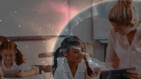 Teacher pointing activating globe overlay while students tapping tablets in classroom for learning. Education, digital learning, classroom, technology, innovation, collaboration, e-learning - Powered by Shutterstock - Get 15% off with code: PIKWIZARD15