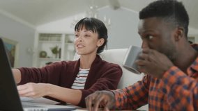 woman tapping laptop keys sparking couple collaborating on technology task while man sipping coffee. Collaboration, teamwork, communication, productivity, home office, modern, freelancing - Powered by Shutterstock - Get 15% off with code: PIKWIZARD15