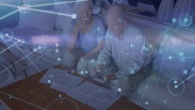 senior couple reaching for smartphone and tapping finance app tracking bills while overlay pulses. Elderly, technology, connection, collaboration, wellness, comfort, digital - Powered by Shutterstock - Get 15% off with code: PIKWIZARD15