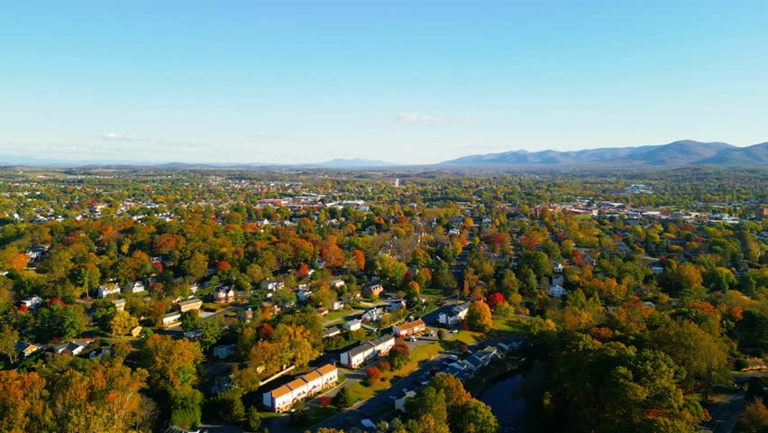 Aerial view of fall foliage in Shenandoah valley with mountain in background. Small town houses with beautiful fall colors 