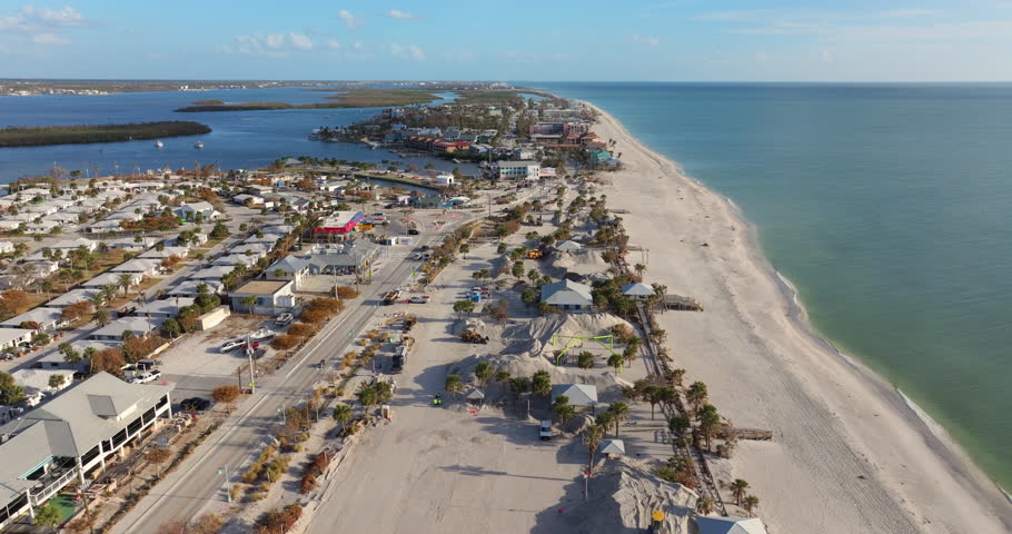 Hurricane Milton aftermath cleanup. Sand recipient site for residents to dump sand after storm surge. Huge sand piles at Englewood Beach on Manasota Key.