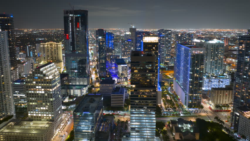 Urban night landscape of downtown district of Miami Brickell in Florida, USA. Skyline with brightly illuminated high skyscraper buildings in modern American megapolis