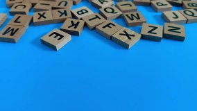 Scattered alphabet letters on a blue surface for a game - Powered by Shutterstock - Get 15% off with code: PIKWIZARD15