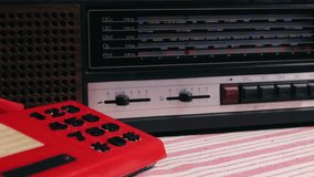 Retro vintage red phone, telephone is displayed on a wooden desk, adding a nostalgic touch. Man answer for call on button 90 phone.  - Powered by Shutterstock - Get 15% off with code: PIKWIZARD15