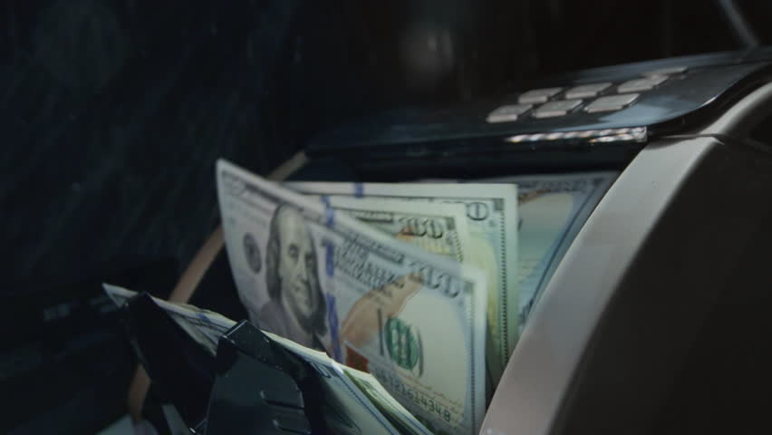 Money cash counting equipment machine. Quick credit or loan, mortgage. Payment and calculation finances. Close-up view of money counter with cash. Banking, investment and currency exchange concept.