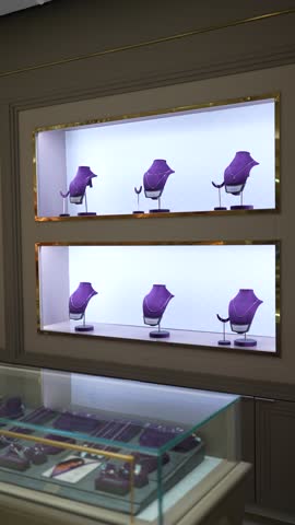 Close-in shot of six platinum necklaces with matching accessories arranged on a display shelf.