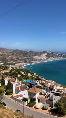 A slightly stormy Mediterranean Sea in La Herradura, Andalusia, Spain, with rolling waves and dramatic coastal light.