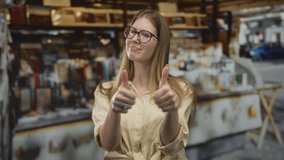 Woman with long blonde hair wearing beige buttoned shirt and red framed glasses giving double thumbs up gesture in a busy street market; confidence. - Powered by Shutterstock - Get 15% off with code: PIKWIZARD15