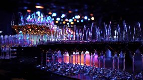 White and red wine in glasses at a party. Beautifully shiny glasses of white and red wine sparkle against the background of illumination. Wine glasses with good lighting. A waiter pours wine into - Powered by Shutterstock - Get 15% off with code: PIKWIZARD15