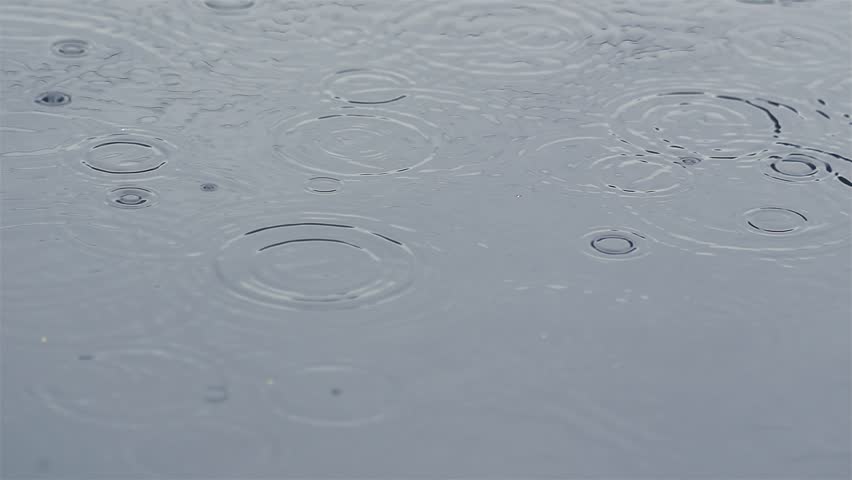 It Is Raining and Raindrops Falling on Water Surface, Slow Motion Rain Background