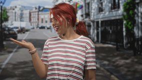 Woman palm up gesture on street wearing striped shirt smiling and offering with open hand; welcoming joy. - Powered by Shutterstock - Get 15% off with code: PIKWIZARD15